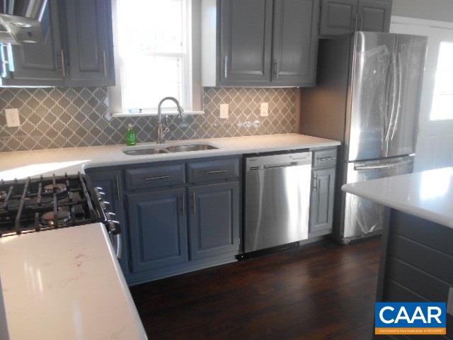 3232 Briery Road Keysville, VA 23947 - Photo 16 of 32 a kitchen with a sink a refrigerator and wooden cabinets