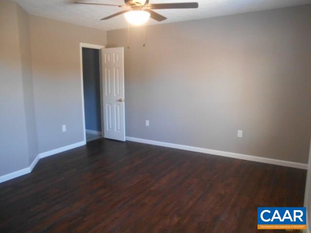3232 Briery Road Keysville, VA 23947 - Photo 23 of 32 an empty room with wooden floor and windows