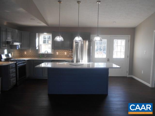 3232 Briery Road Keysville, VA 23947 - Photo 10 of 32 a kitchen with a table chairs and a wooden floor