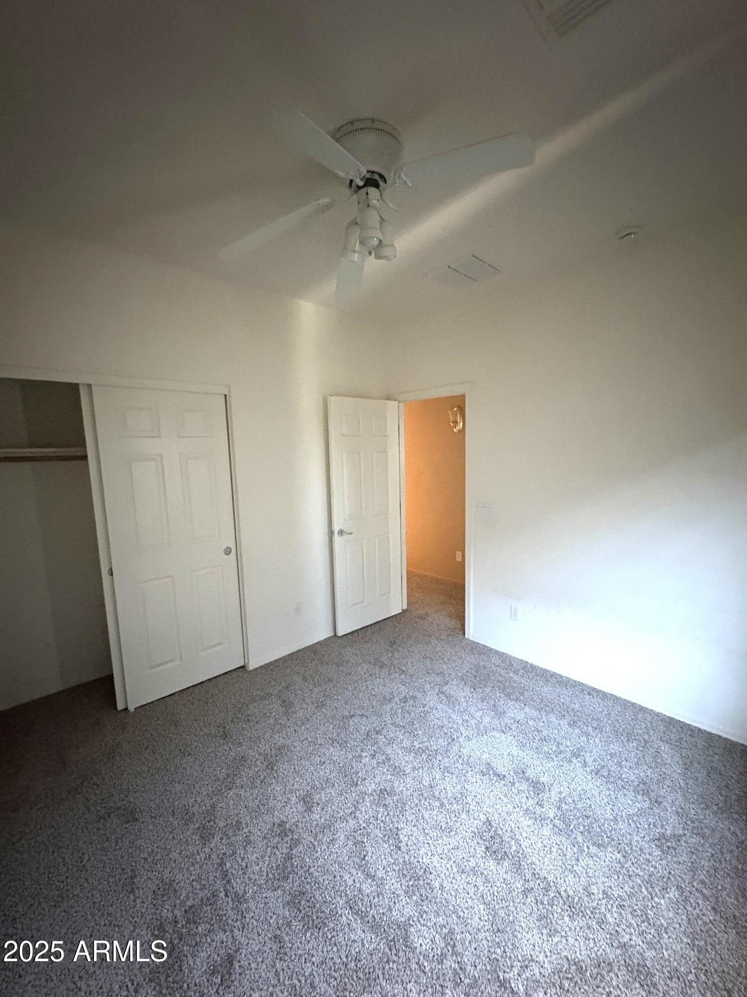 3057 East Pinto Valley Road San Tan Valley, AZ 85143 - Photo 15 of 17 an empty room with a ceiling fan and window