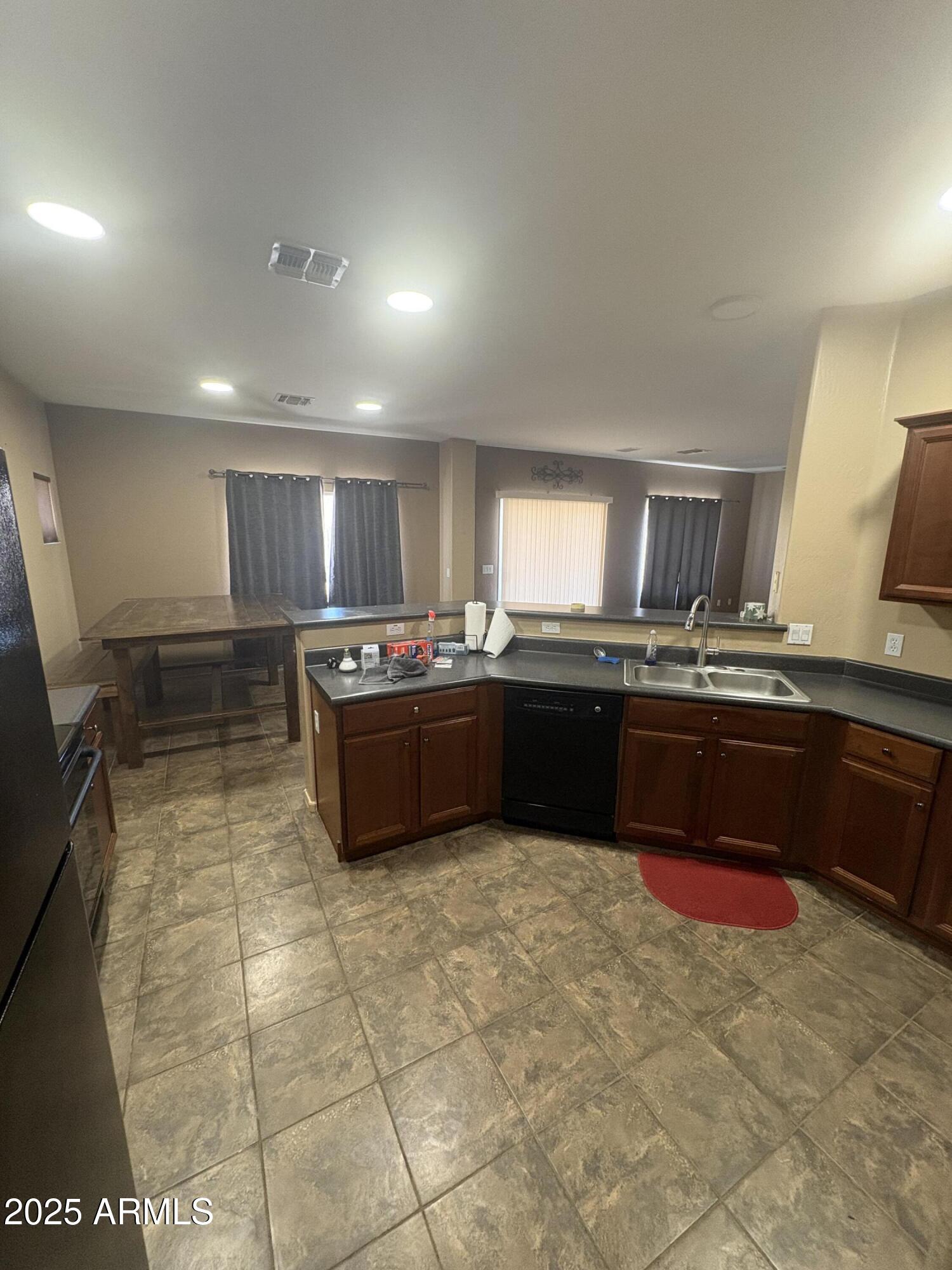 3057 East Pinto Valley Road San Tan Valley, AZ 85143 - Photo 3 of 17 a kitchen with kitchen island granite countertop a sink a counter top space and appliances