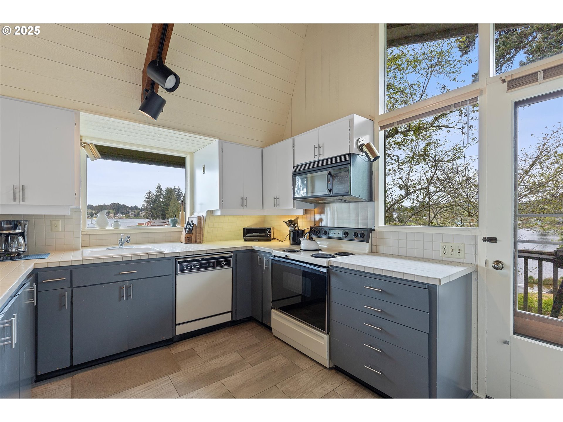 2871 Northeast East Devils Lake Road Otis, OR 97368 - Photo 12 of 48 a kitchen with a sink window and cabinets