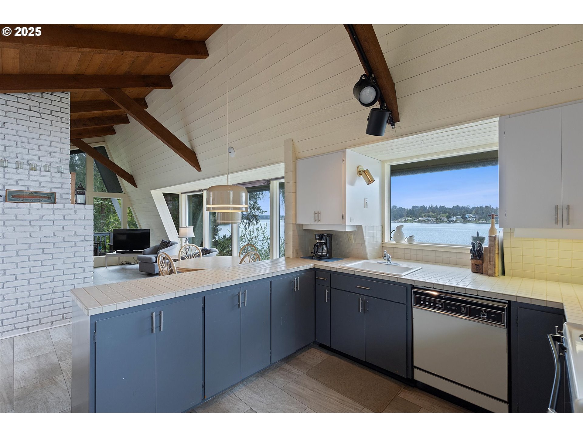 2871 Northeast East Devils Lake Road Otis, OR 97368 - Photo 13 of 48 a kitchen with a sink a stove and cabinets