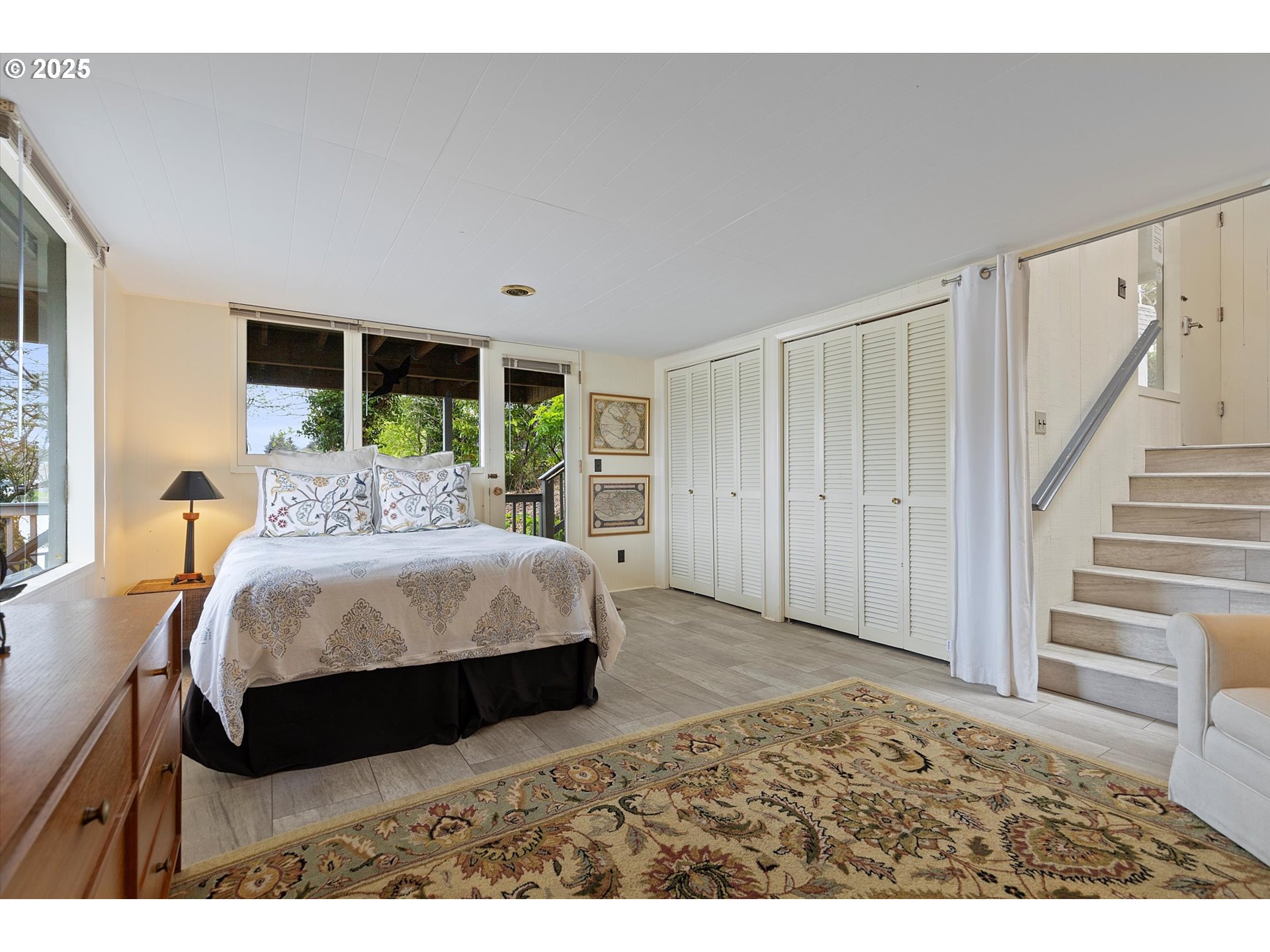 2871 Northeast East Devils Lake Road Otis, OR 97368 - Photo 23 of 48 a bed sitting in a bedroom next to a window