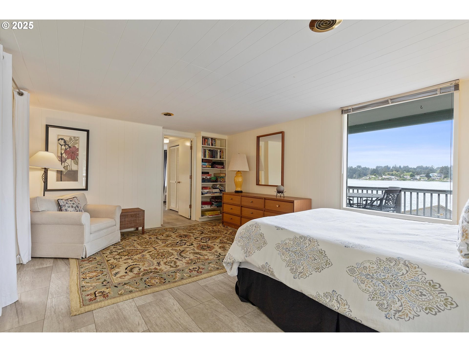 2871 Northeast East Devils Lake Road Otis, OR 97368 - Photo 24 of 48 a living room with a bed furniture and next to a window