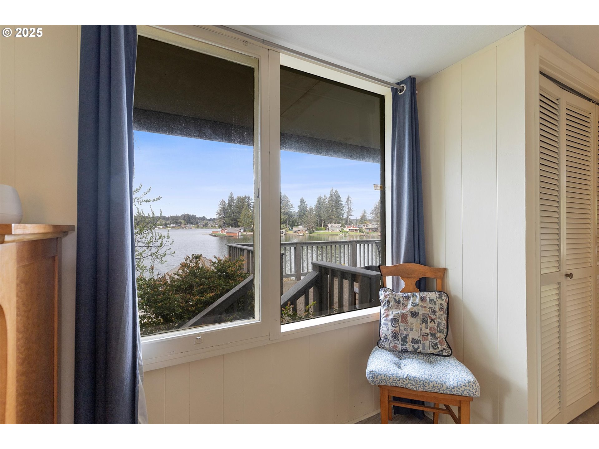 2871 Northeast East Devils Lake Road Otis, OR 97368 - Photo 32 of 48 a bathroom with a large window and a bed