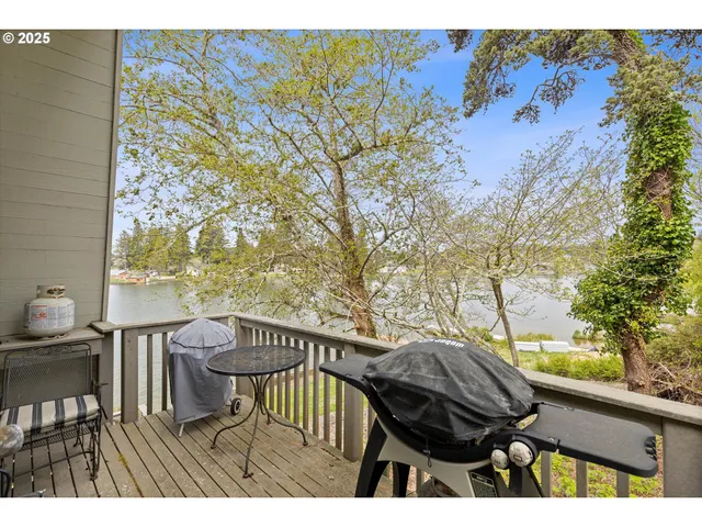 a view of a balcony with wooden floor and outdoor seating