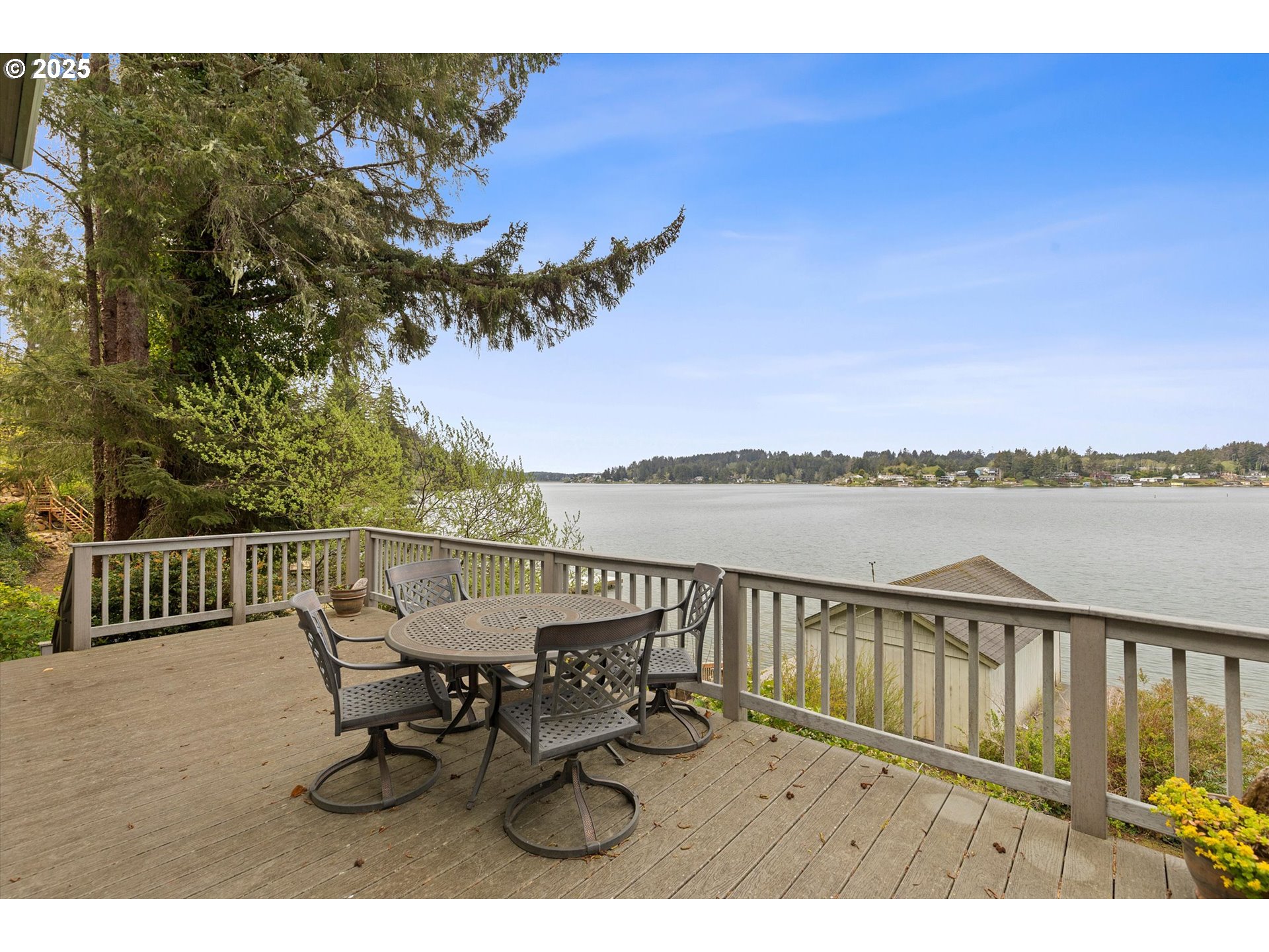 2871 Northeast East Devils Lake Road Otis, OR 97368 - Photo 37 of 48 a view of a balcony with wooden floor and outdoor seating