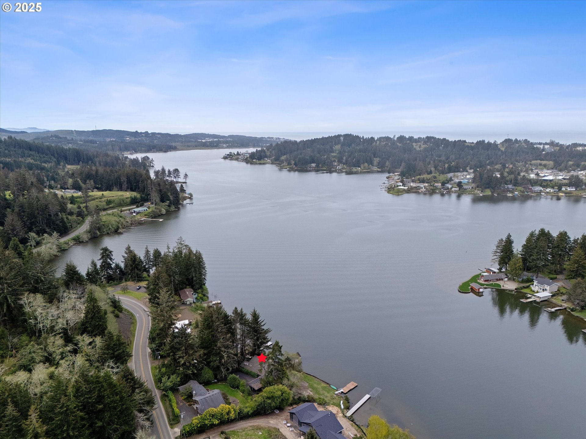 2871 Northeast East Devils Lake Road Otis, OR 97368 - Photo 43 of 48 a view of a lake with a city
