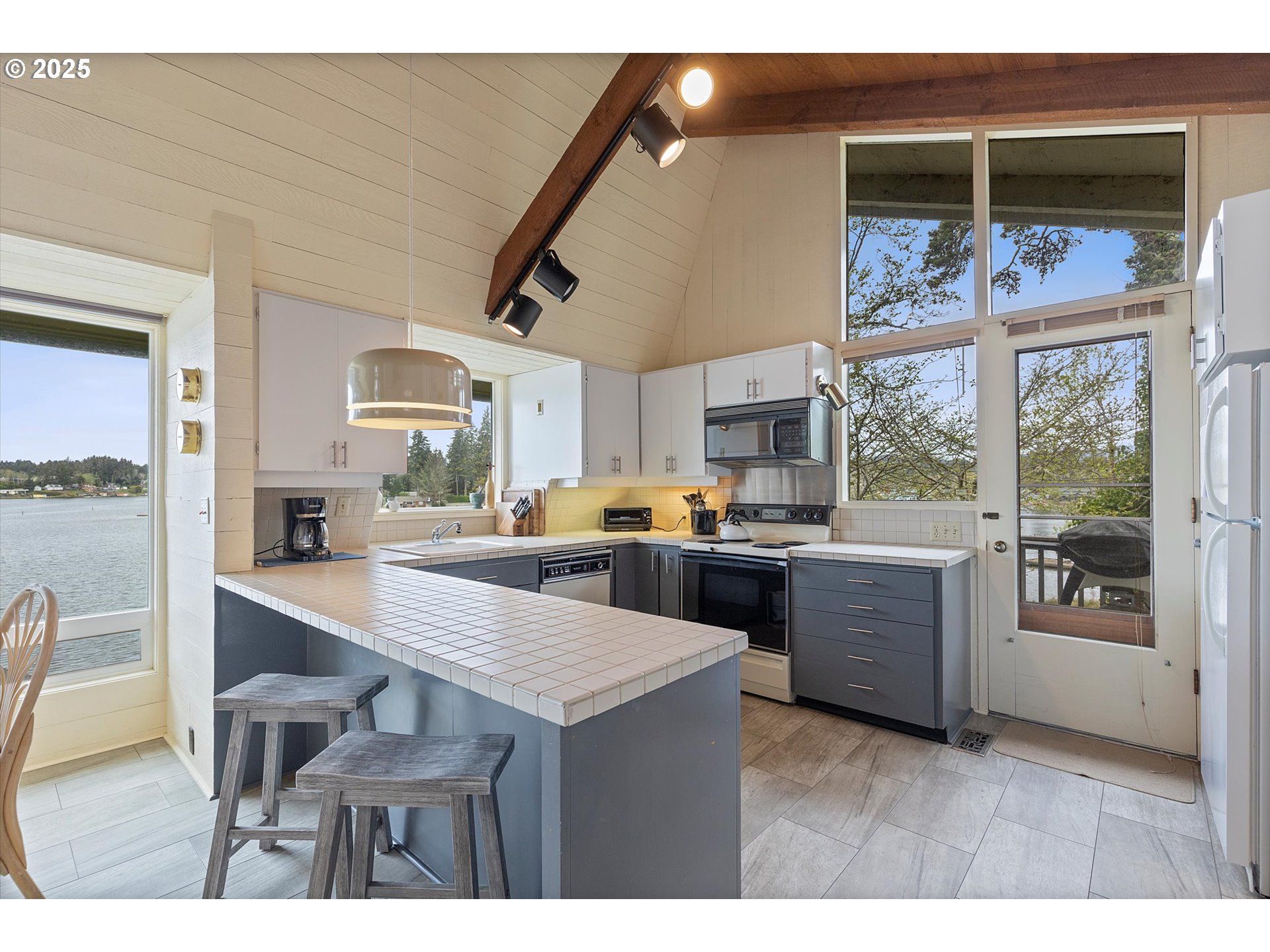 2871 Northeast East Devils Lake Road Otis, OR 97368 - Photo 10 of 48 a kitchen with a table and chairs in it