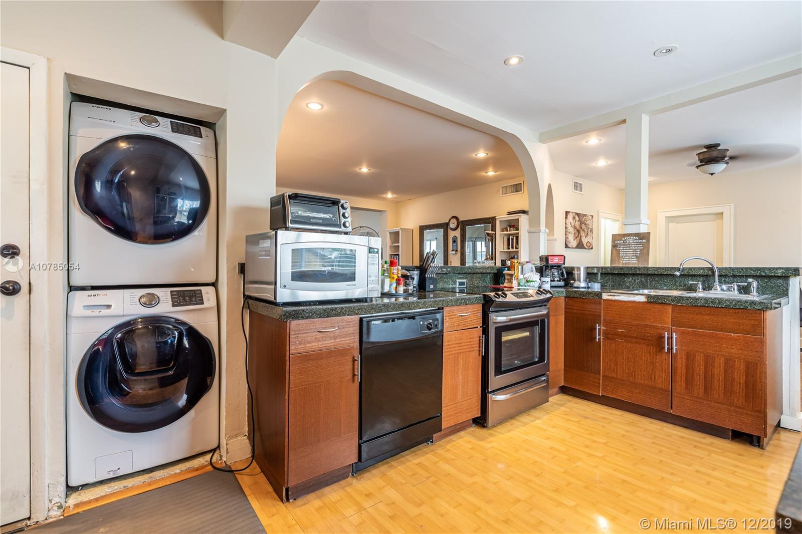 6342 Southwest 23rd Street Miami, FL 33155 - Photo 15 of 37 laundry inside the kitchen, modern washer/dryer.
