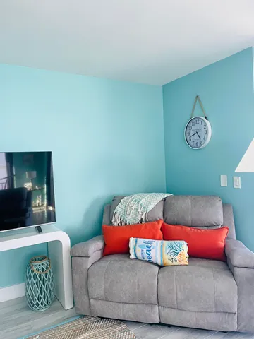 a view of a room with furniture wooden floor and window