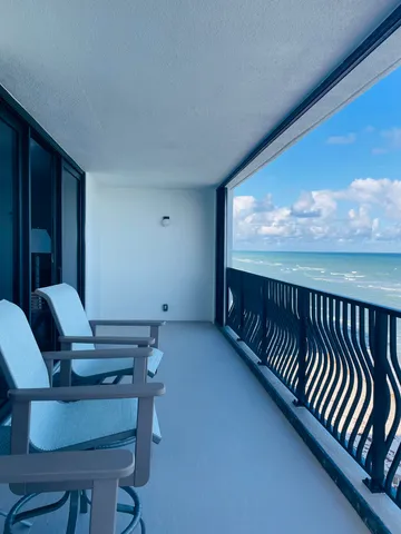 a view of a refrigerator in kitchen and livingroom