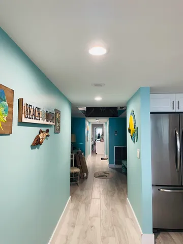 a bedroom with a bed and painting on the wall