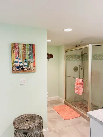a bathroom with a sink toilet vanity and shower