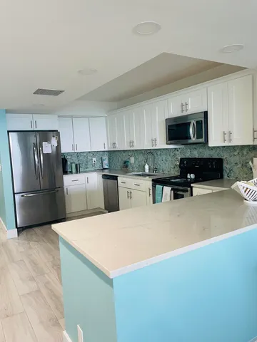 a dining room with furniture and painting on the wall