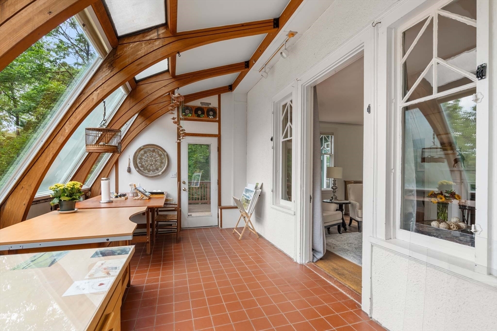 121 Bishopsgate Road Newton, MA 02459 - Photo 17 of 34 a view of a hallway with wooden floor and a dining table
