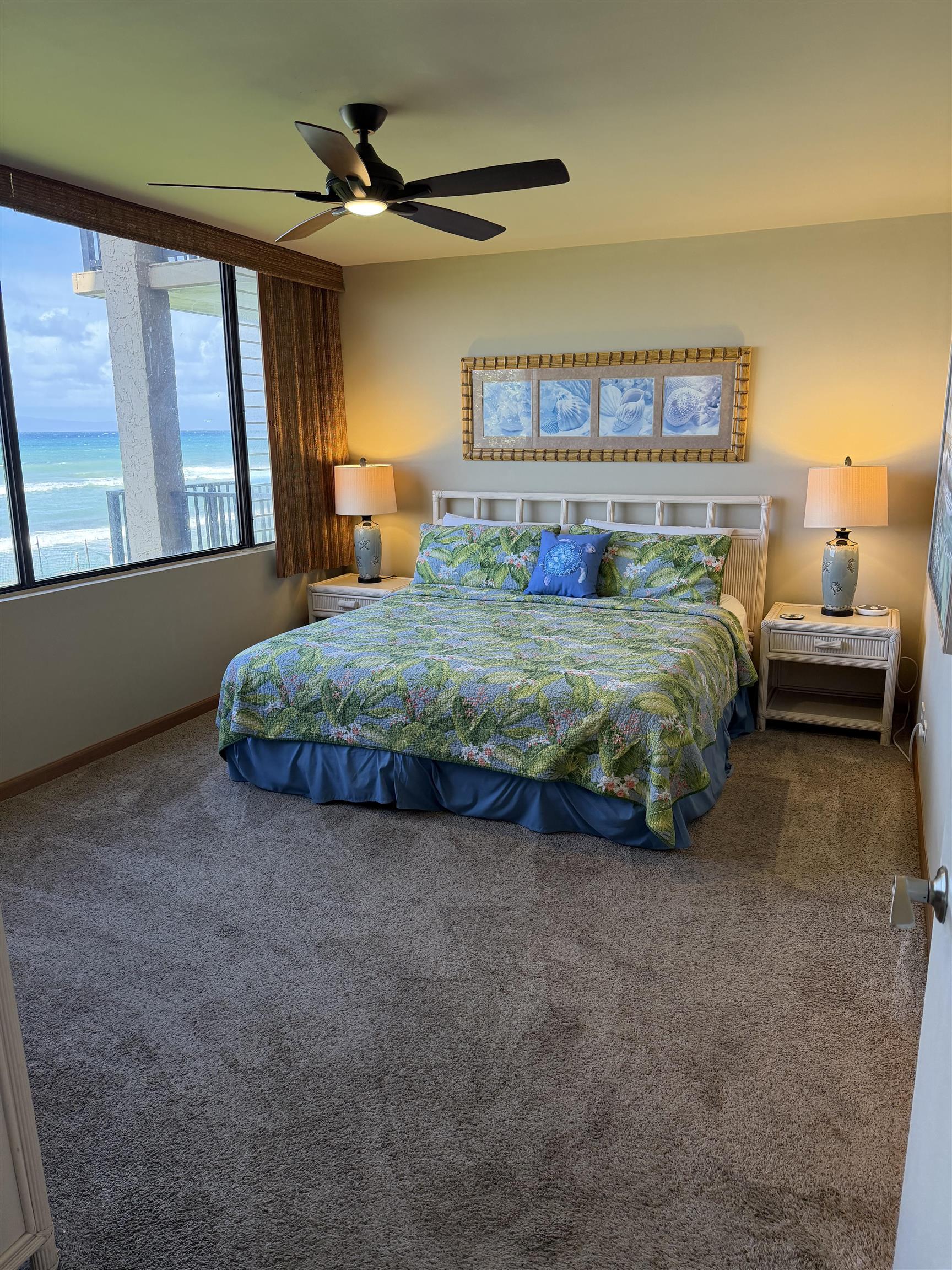 3543 Lower Honoapiilani Road, Unit L202 Lahaina, HI 96761 - Photo 7 of 22 a spacious bedroom with a bed and a chandelier