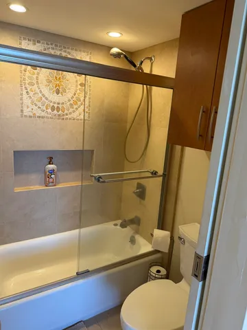 a bathroom with a sink mirror bathtub and toilet