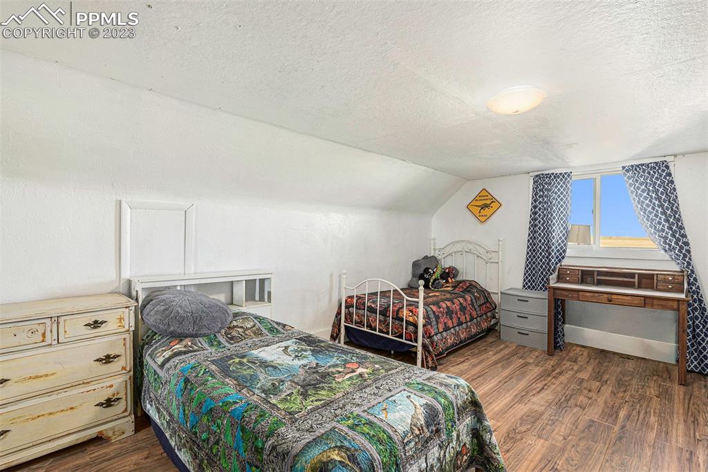 2905 Lauppe Road Yoder, CO 80864 - Photo 11 of 34 a bedroom with two beds and painting on the wall