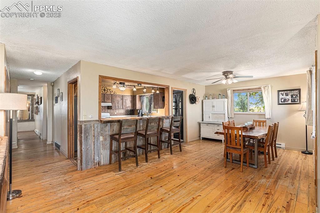 2905 Lauppe Road Yoder, CO 80864 - Photo 15 of 34 a dining room with furniture and wooden floor