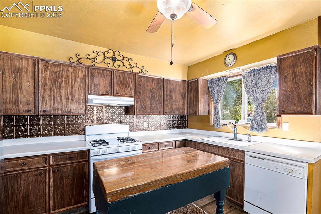 2905 Lauppe Road Yoder, CO 80864 - Photo 17 of 34 a kitchen with a sink a stove and a cabinets