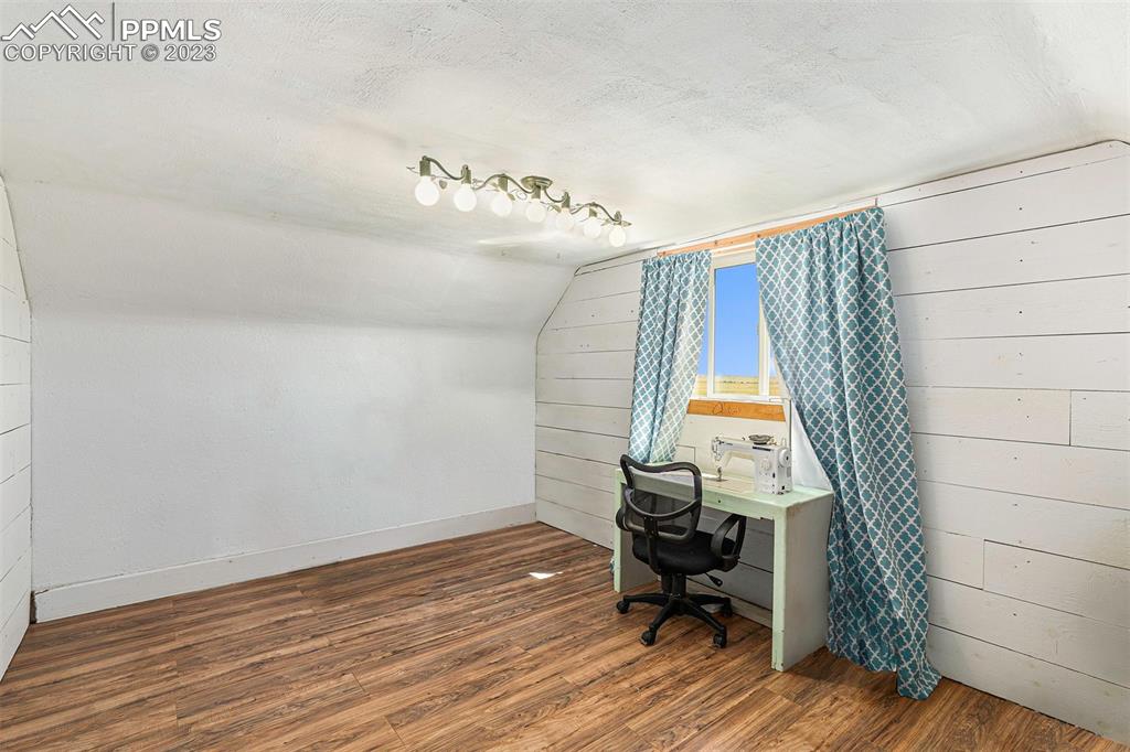 2905 Lauppe Road Yoder, CO 80864 - Photo 20 of 34 a view of a room with wooden floor and chair