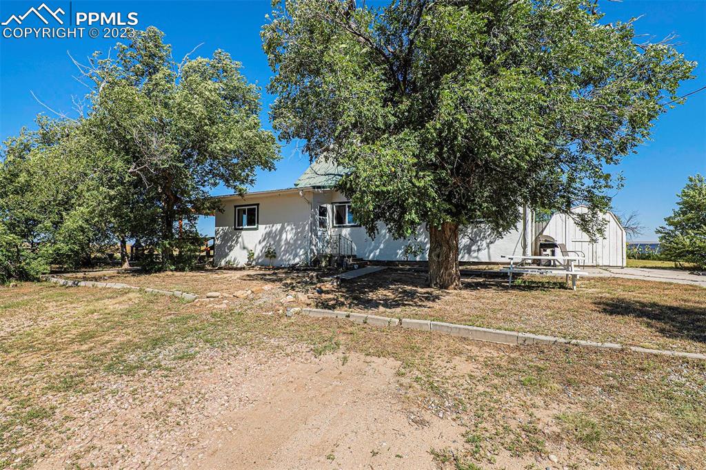 2905 Lauppe Road Yoder, CO 80864 - Photo 29 of 34 a front view of a house with a yard and garage