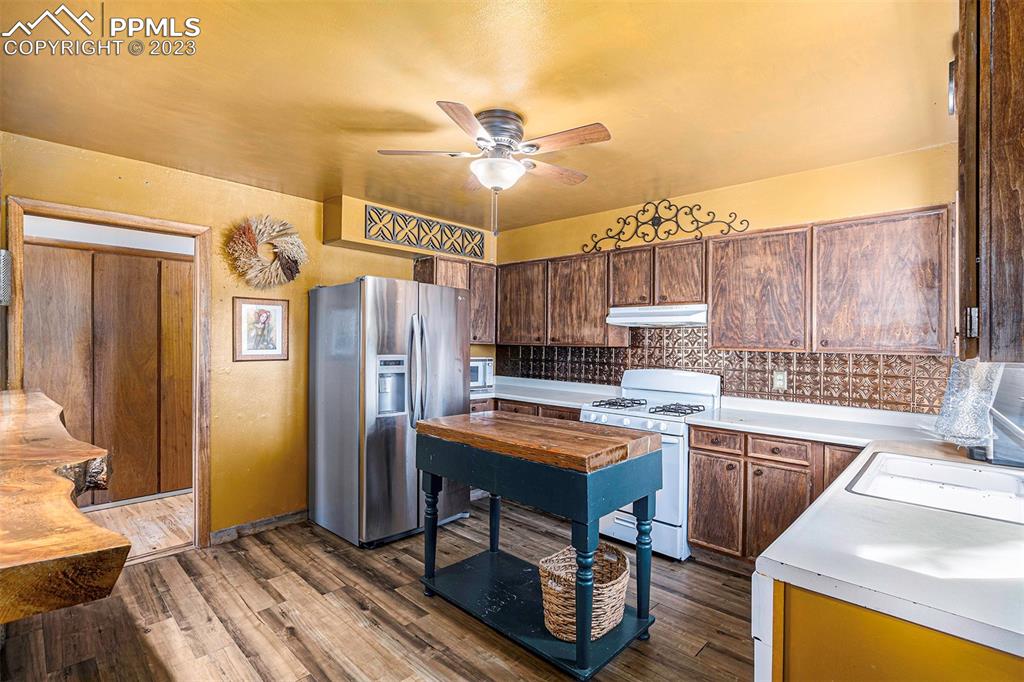 2905 Lauppe Road Yoder, CO 80864 - Photo 4 of 34 a kitchen that has a lot of cabinets in it and stainless steel appliances