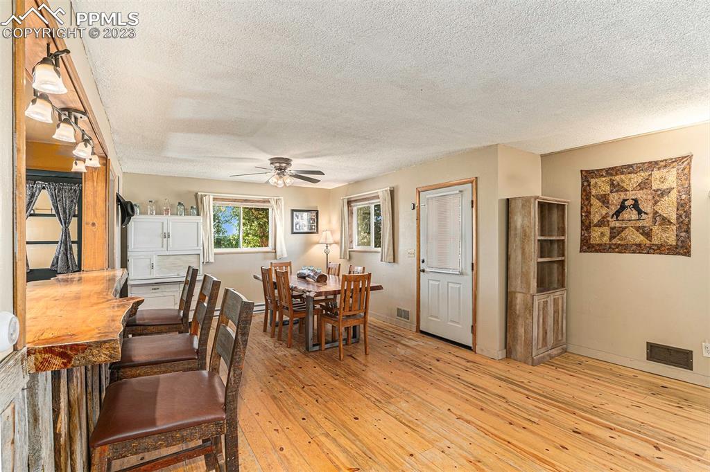 2905 Lauppe Road Yoder, CO 80864 - Photo 9 of 34 a view of a dining room with furniture window and wooden floor