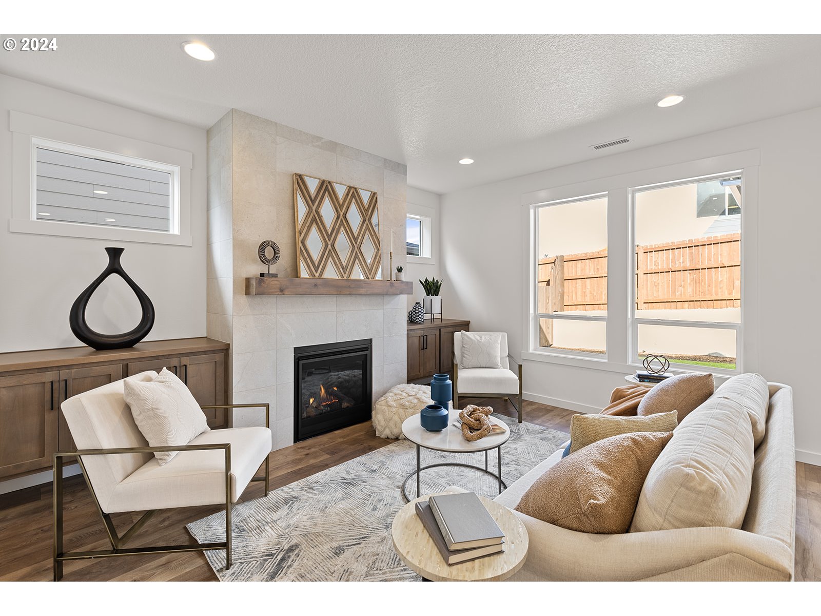 918 Northwest 178th Street Ridgefield, WA 98642 - Photo 15 of 47 a living room with furniture a fireplace and floor to ceiling windows