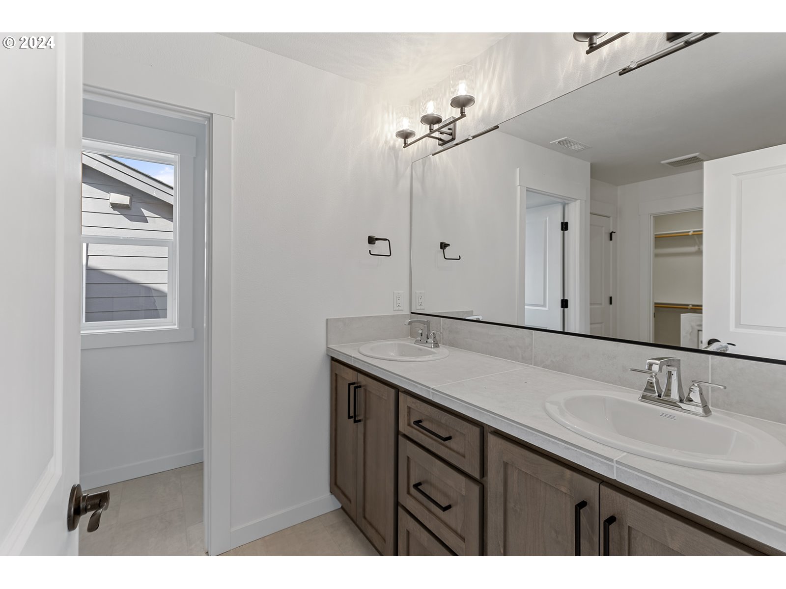 918 Northwest 178th Street Ridgefield, WA 98642 - Photo 36 of 47 a bathroom with a sink double vanity and a mirror
