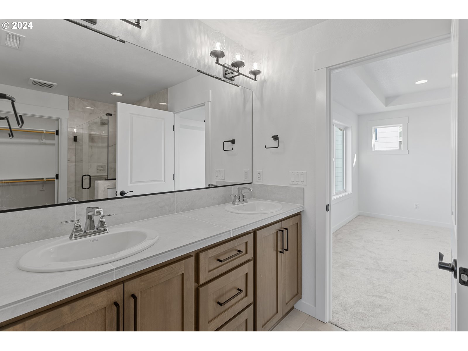 918 Northwest 178th Street Ridgefield, WA 98642 - Photo 38 of 47 a bathroom with a sink double vanity and a mirror