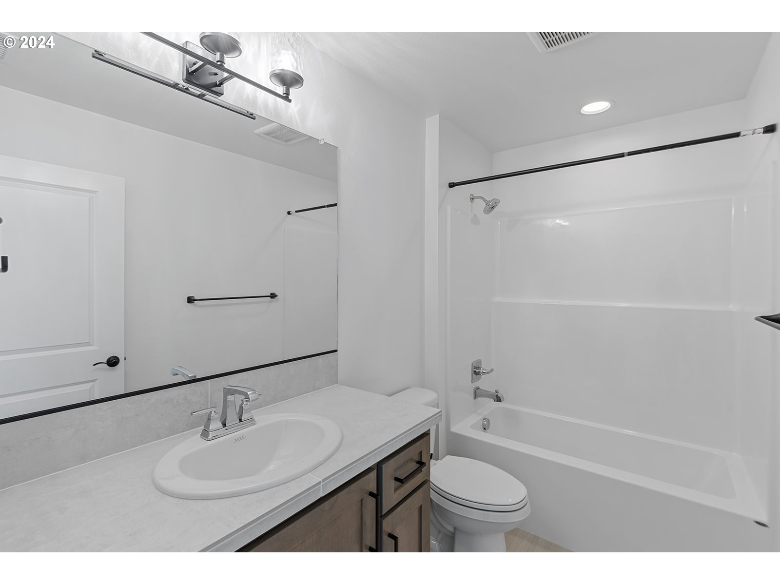 918 Northwest 178th Street Ridgefield, WA 98642 - Photo 46 of 47 a bathroom with a granite countertop sink toilet a shower and a mirror