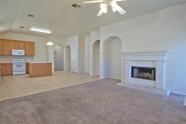 a view of an empty room with a fireplace