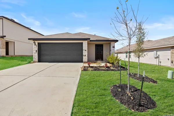 a front view of a house with yard