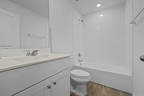 a view of a kitchen with a sink and dishwasher wooden floor