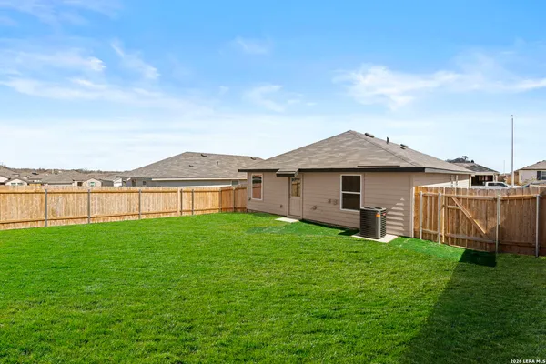 a view of a yard with a house in the background