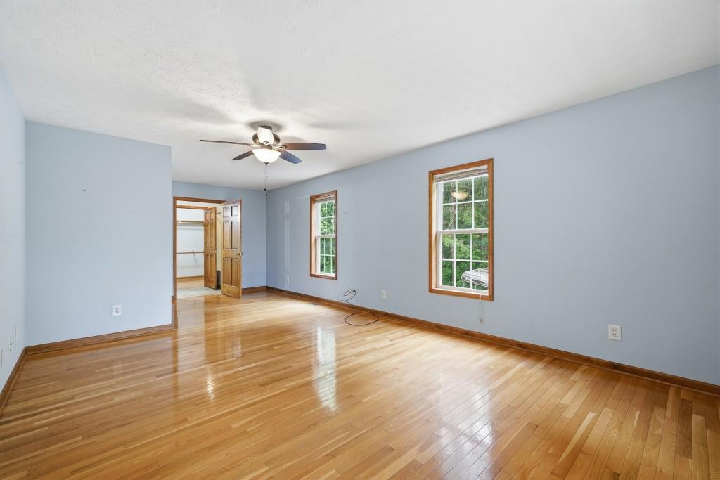 176 Big Oak Tree Road Northwest Adairsville, GA 30103 - Photo 27 of 77 a view of an empty room with window and wooden floor