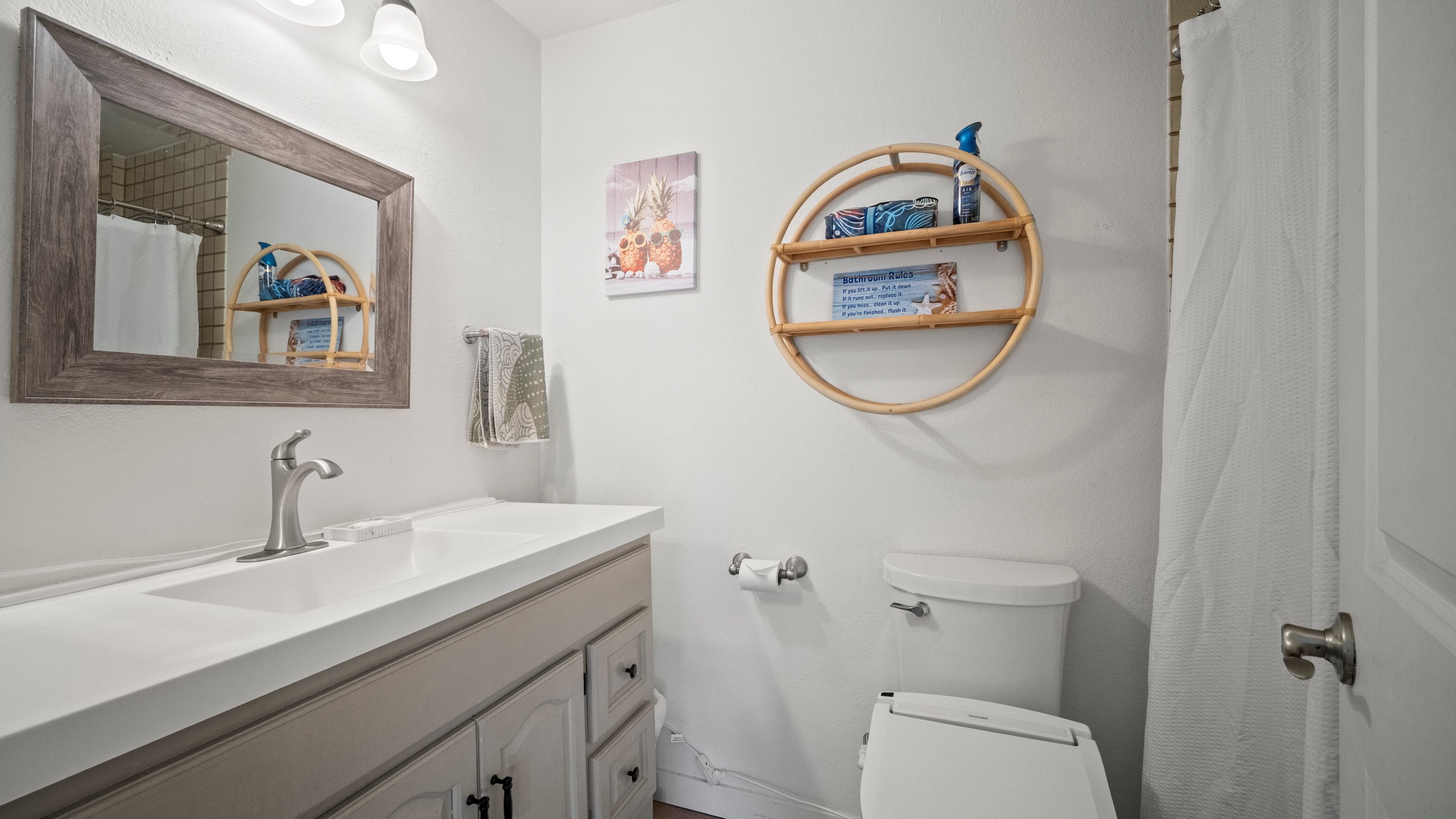 4121 Rice Street, Unit 2708 Lihue, HI 96766 - Photo 21 of 29 a bathroom with a sink a mirror a toilet and a mirror