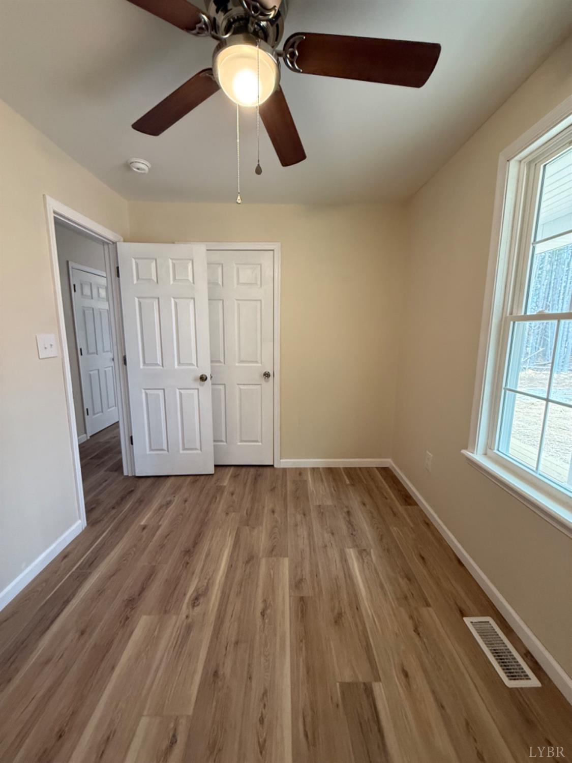 4103 Hog Wallow Road Nathalie, VA 24577 - Photo 11 of 20 wooden floor in an empty room with a window