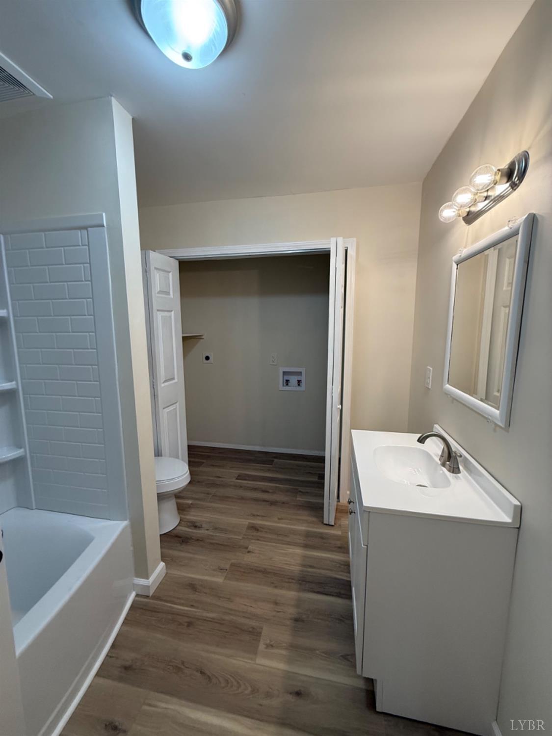 4103 Hog Wallow Road Nathalie, VA 24577 - Photo 13 of 20 a bathroom with a sink a mirror and a bathtub