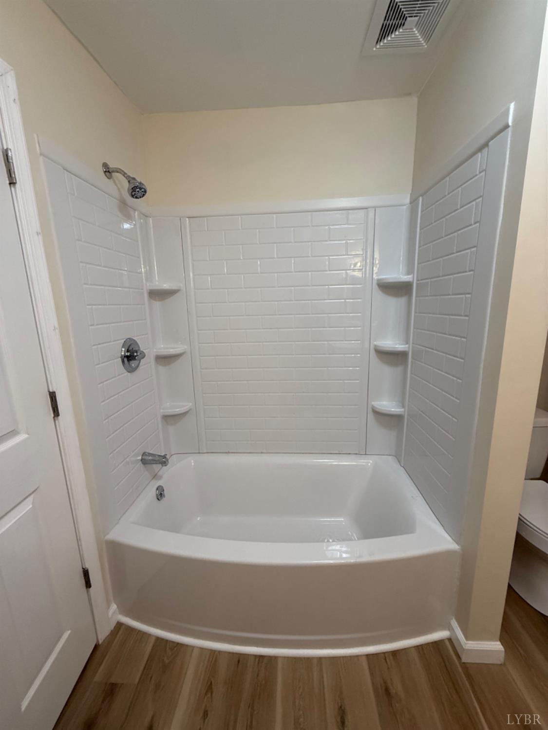 4103 Hog Wallow Road Nathalie, VA 24577 - Photo 14 of 20 a white bath tub sitting next to a white sink and vanity