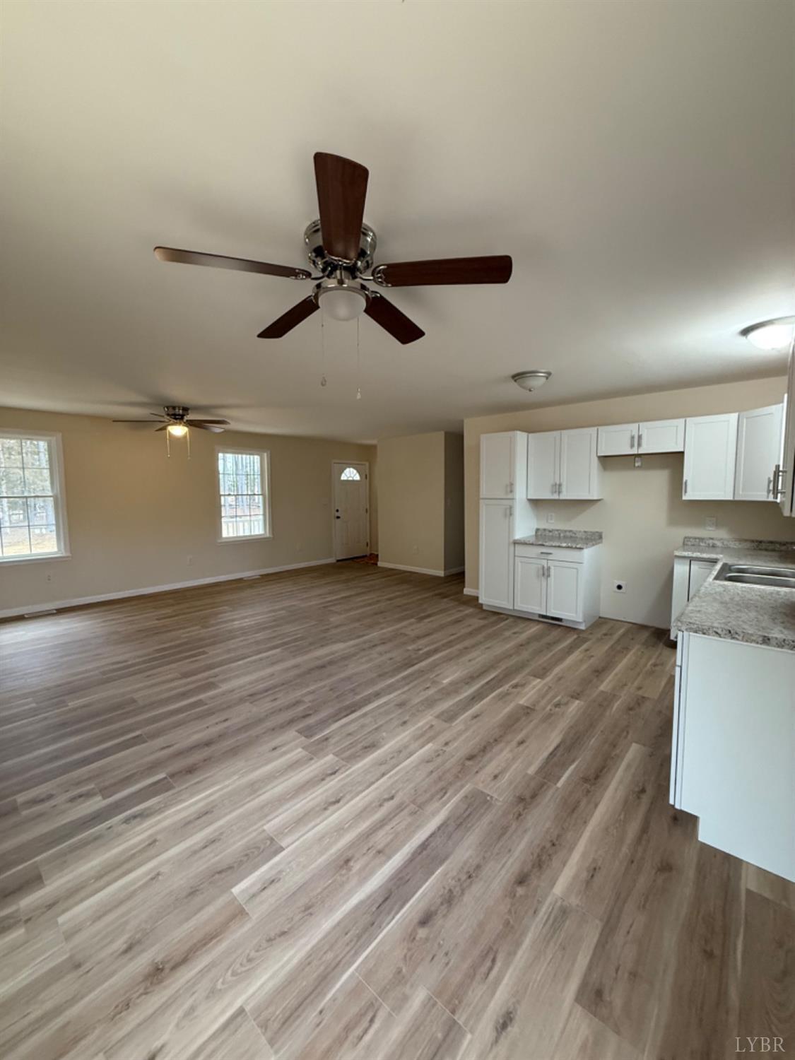 4103 Hog Wallow Road Nathalie, VA 24577 - Photo 6 of 20 a view of kitchen and empty room with wooden floor