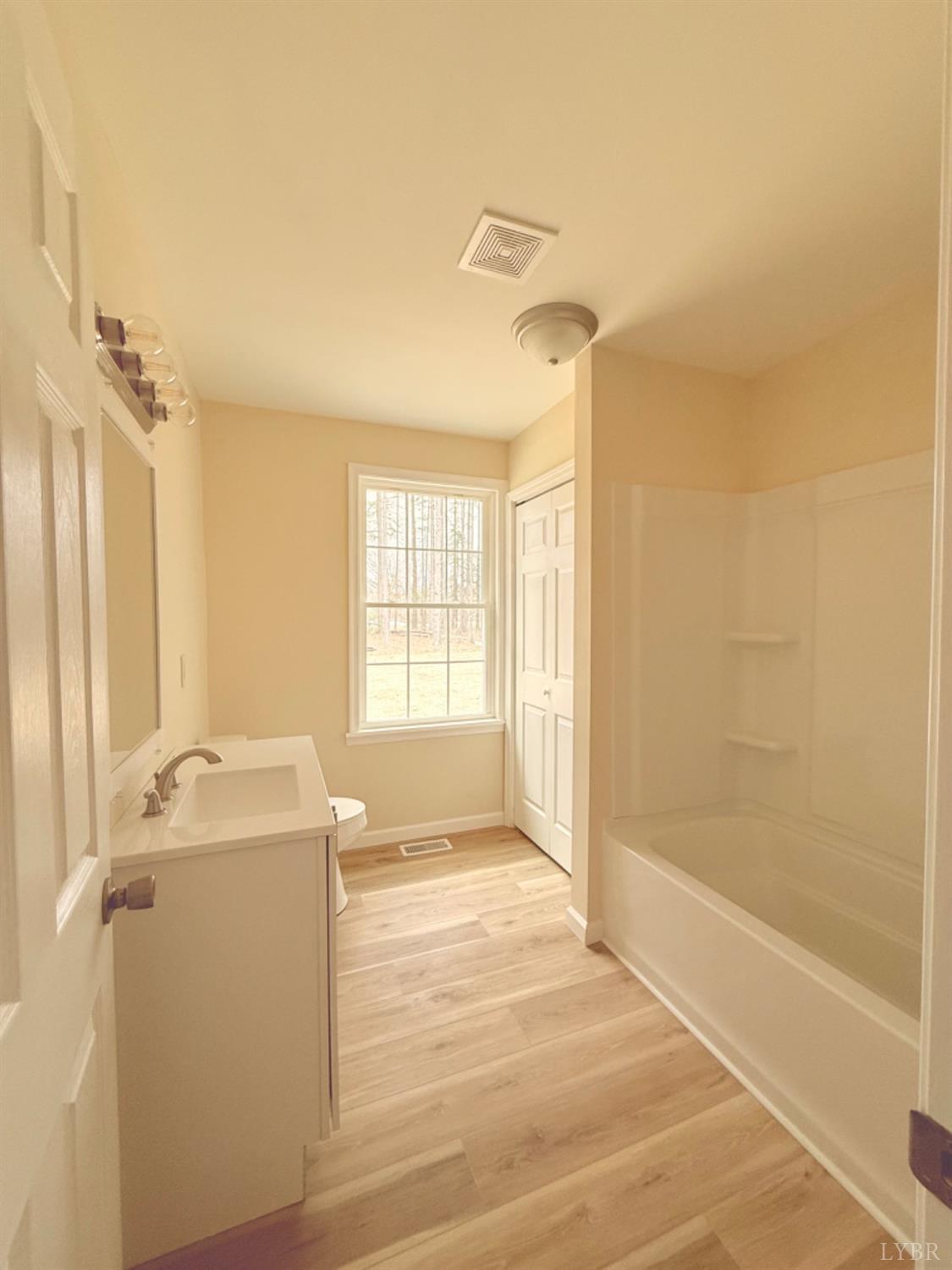 4103 Hog Wallow Road Nathalie, VA 24577 - Photo 9 of 20 a bathroom with a granite countertop sink a mirror and a bathtub