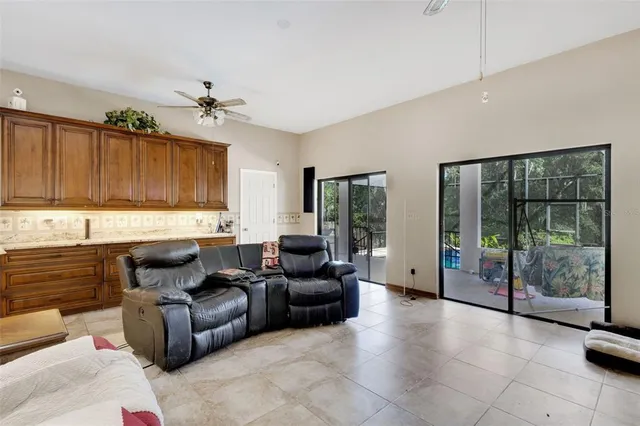 a living room with furniture and large windows