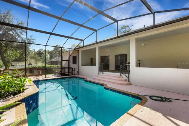 a view of a swimming pool with a patio