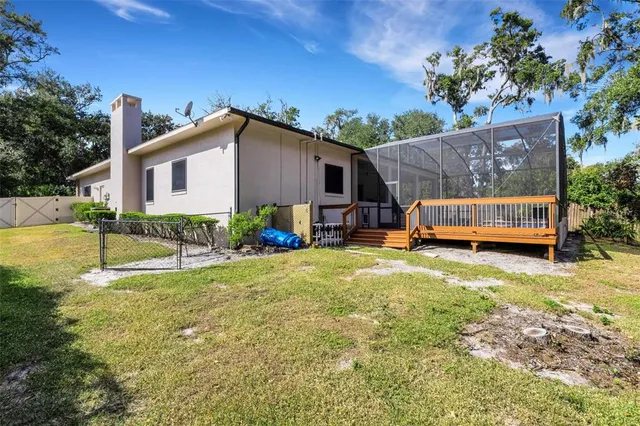 a view of a house with backyard and sitting area