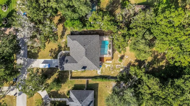 an aerial view of a house with a yard