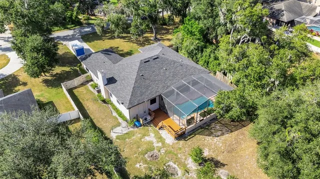 an aerial view of a house with swimming pool and garden space